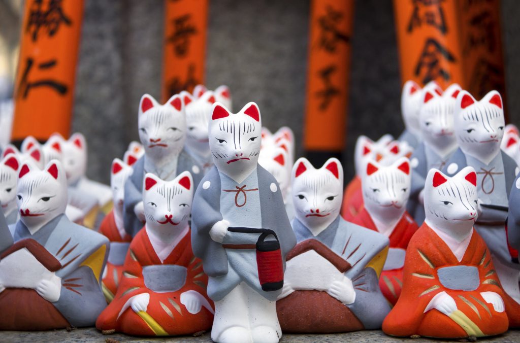 Little fox statues at Fushimi Inari Shrine in Kyoto, Japan