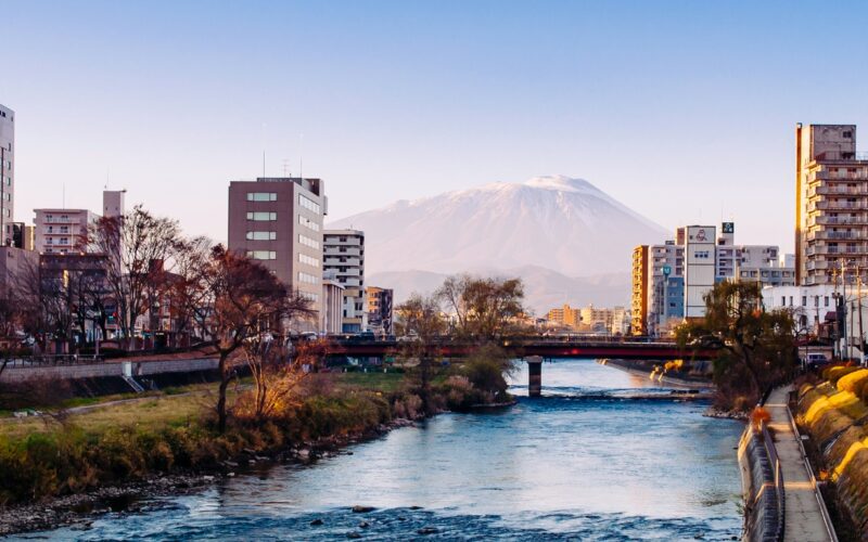 Mount Iwate Morioka city scene with buildings and promenade at Katakami river with warm sunset light