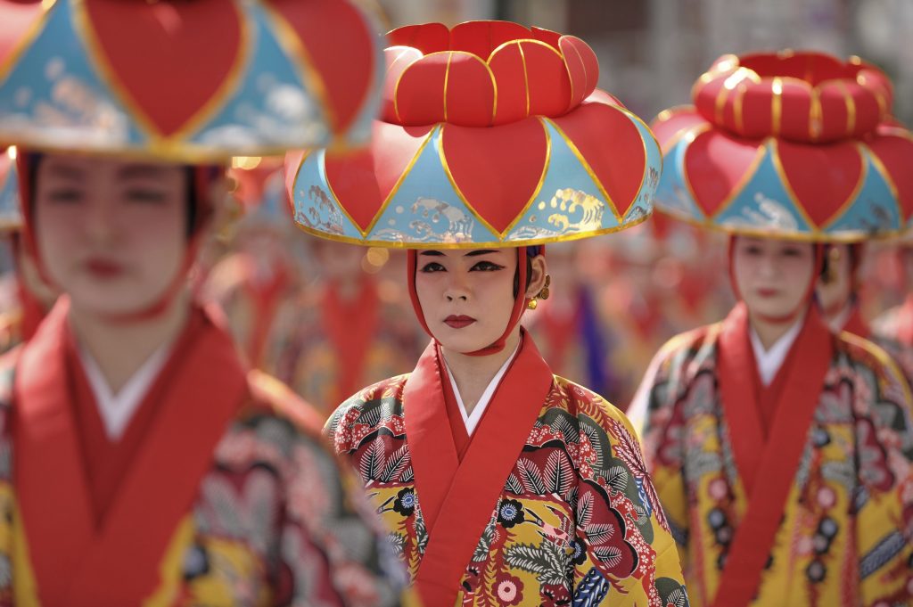 "Naha City. Traditional dance performers make their way down "Kokusai St." (International St.) during a local festival."