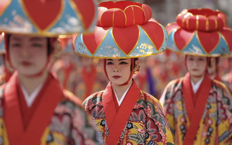 "Naha City. Traditional dance performers make their way down "Kokusai St." (International St.) during a local festival."