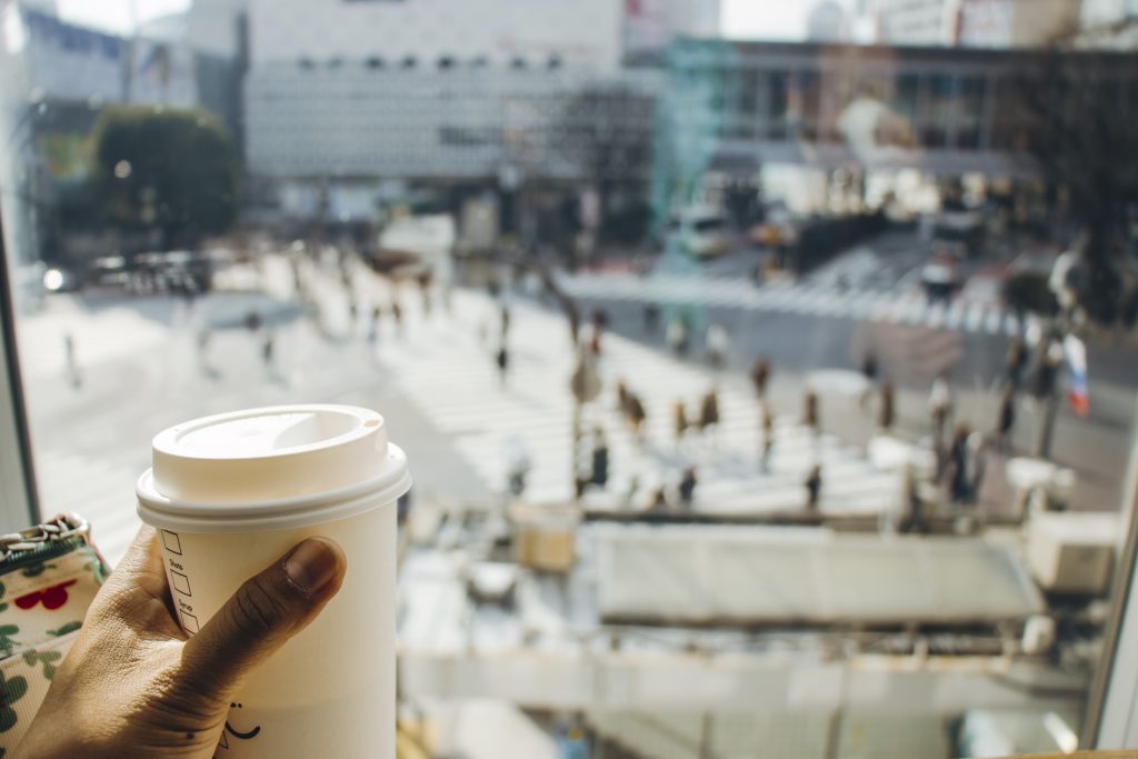 Coffee time in rush hour of Tokyo with a blur of people Scrarmble Crossing , Tokyo, Japan